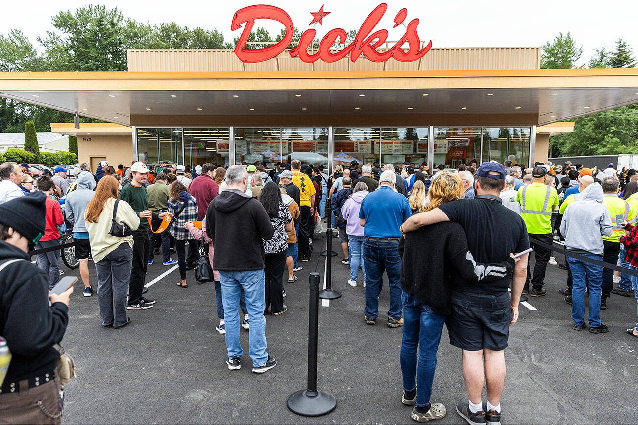 Hundreds wait in line to order after the grand opening of Dick’s Drive-In’s new location in Everett on Thursday, June 12, 2025 in Everett, Washington. (Olivia Vanni / The Herald)