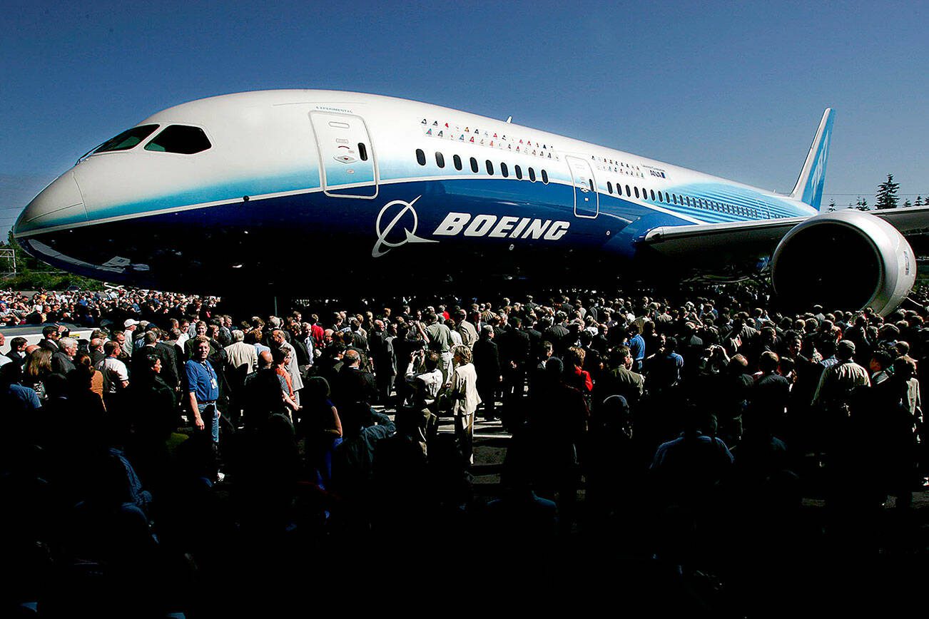 Herald staff photo by Michael O'Leary 070807
DREAMLINER - The first Boeing 787 is swarmed by the crowd attending the roll out of the plane in on July 8, 2007 at the Boeing assembly facility in Everett.