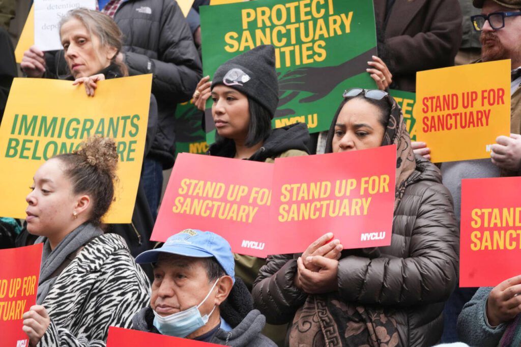 Supporters of New York immigrants and sanctuary cities gather on the steps of City Hall in New York on March 5. Protesters in New York demanded in March that the city stand by its policy to protect undocumented immigrants, despite threats from the Trump administration. (Earl Wilson / The New York Times)
