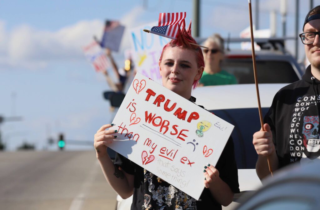 People hold signs during a “No Kings Day” rally along Broadway on Saturday, June 14, 2025, in Everett, Washington. (Mike Henneke / The Herald)
