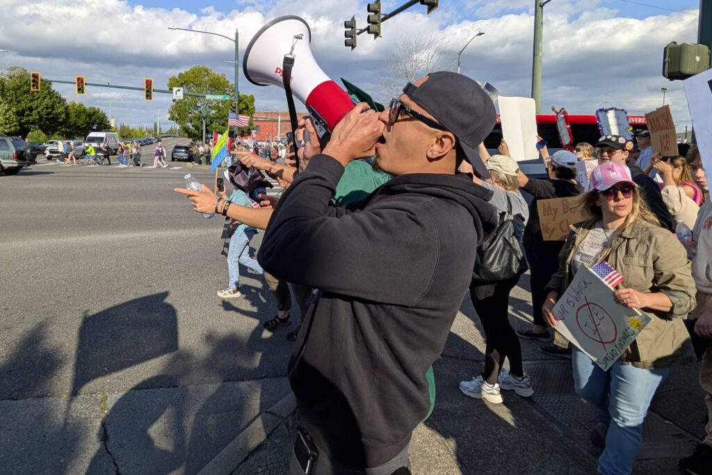 People use bullhorns during a “No Kings Day” rally along Broadway on Saturday, June 14, 2025, in Everett, Washington. (Mike Henneke / The Herald)
