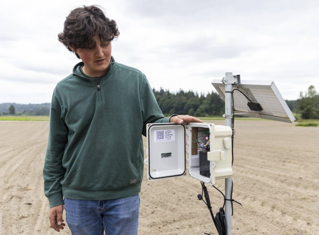 Simon Fuentes, a field technician, talks about the field moisture monitor he installed on Friday, June 13, 2025 in Snohomish, Washington. (Olivia Vanni / The Herald)
