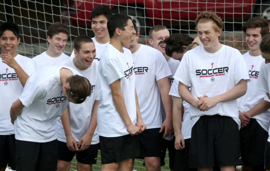 Archbishop Murphy soccer players laugh while trying to make a team video before the start of practice on Tuesday, Mar. 15, 2016 in Washington (Andy Bronson / The Herald)
