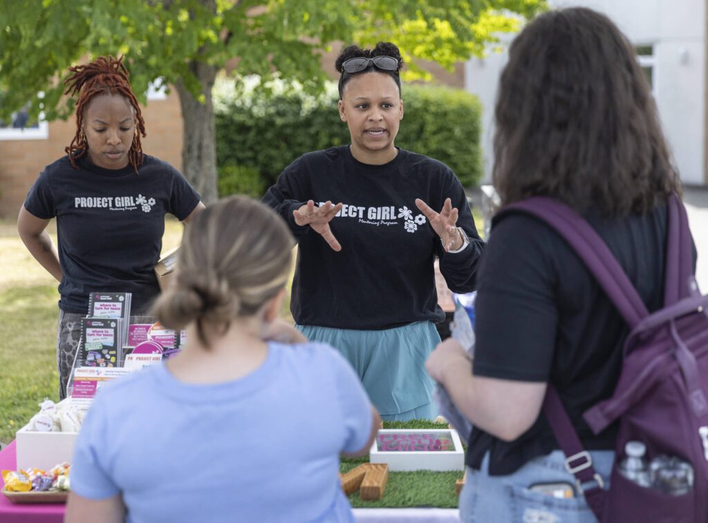 Kamilah Gomez-Monini answers questions about Project Girl during Lynnwood Juneteenth on Thursday, June 19, 2025 in Lynnwood, Washington. (Olivia Vanni / The Herald)
