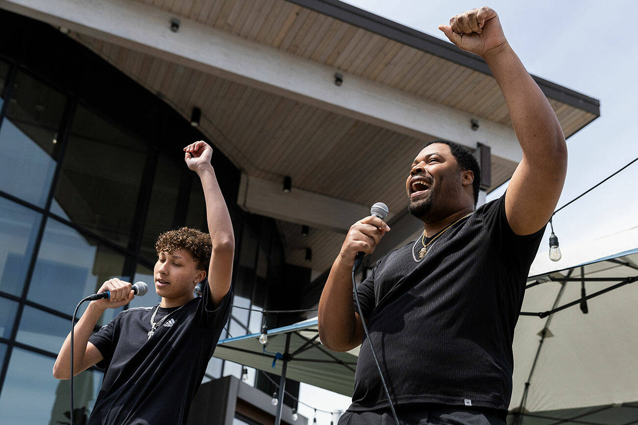 William Luckett, right, and JJ perform a spoken word piece during Juneteenth at the Beach’s Festival of Freedom on Thursday, June 19, 2025 in Edmonds, Washington. (Olivia Vanni / The Herald)