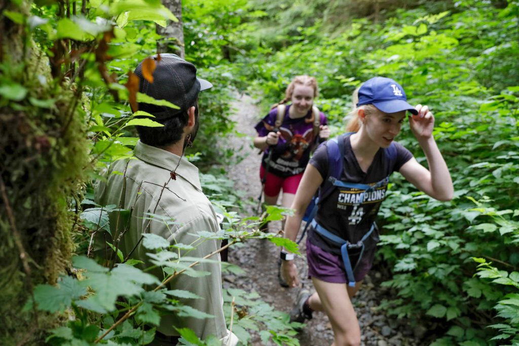 Forest ranger Justin Sundstrom steps off the trail heading to Heather Lake for hikers near Granite Falls, Washington on July 23, 2022. (Kevin Clark / The Herald)
