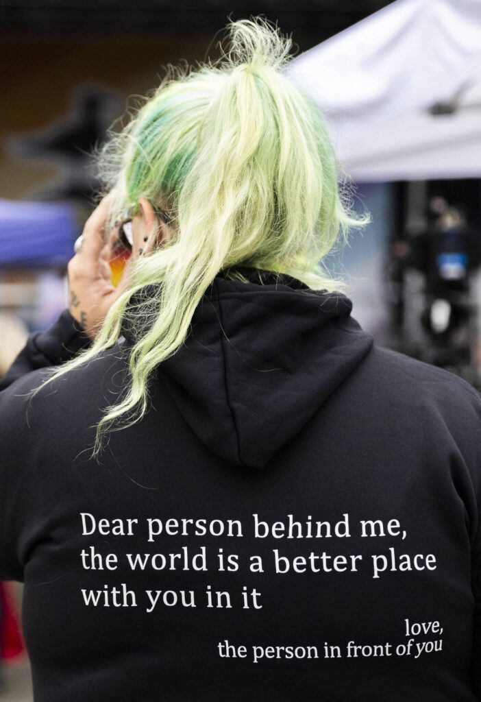 Rene Biggerstaff wears a sweatshirt with the phrase, “Dear person behind me, the world is a better place with you in it,” during the Everett Pride Block Party on Saturday, June 21, 2025 in Everett, Washington. (Olivia Vanni / The Herald)
