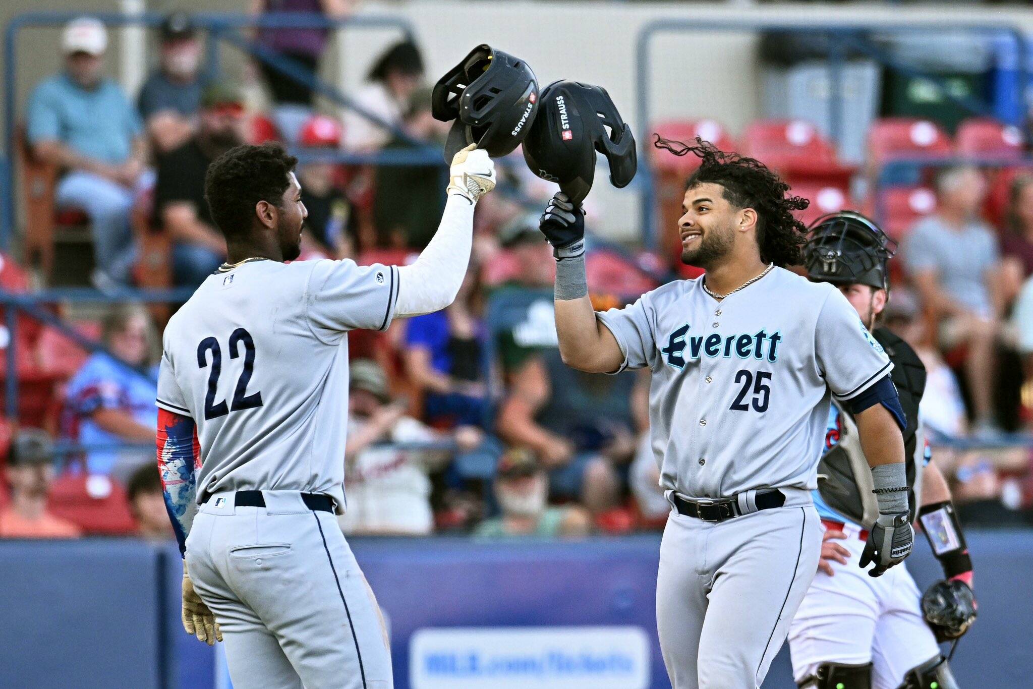 AquaSox designated hitter Freuddy Batista (25) celebrates with right fielder Lazaro Montes (22) during a 9-3 victory over the Spokane Indians on Wednesday, June 18th at Avista Stadium in Spokane. (Photo courtesy of James Snook)