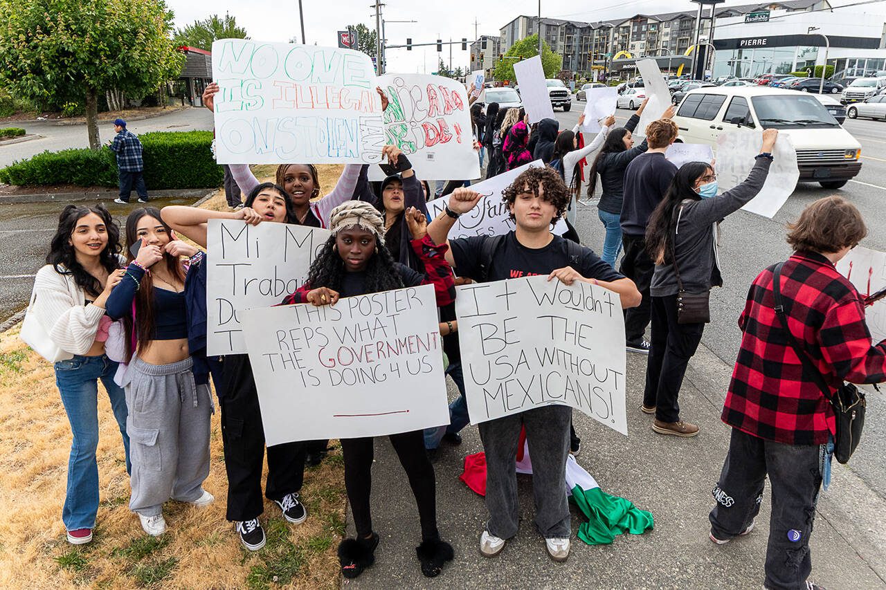 Front, from left, sophomore Sohna Manneh and freshman Shane Martinez organized a walkout protest of mass deportations on the last period of the last day of school at Cascade High School on Friday, June 20, 2025, in Everett, Washington. (Aaron Kennedy / The Herald)