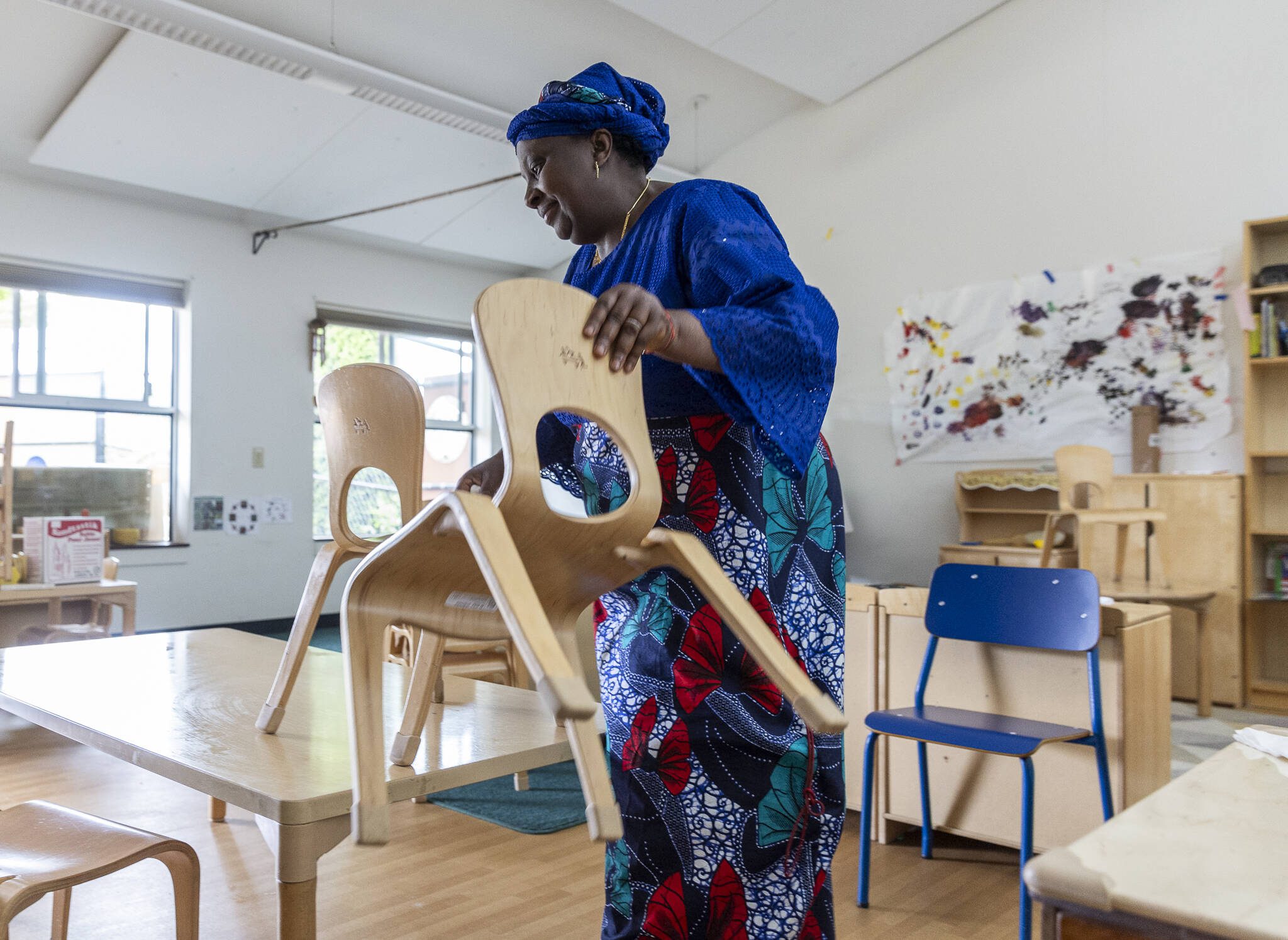 Fatou Drammeh-Darboe, who has taught at the Early Learning Center for 17 years, stacks up chairs in her classroom on the last day of school on Wednesday, June 25, 2025 in Everett, Washington. (Olivia Vanni / The Herald)