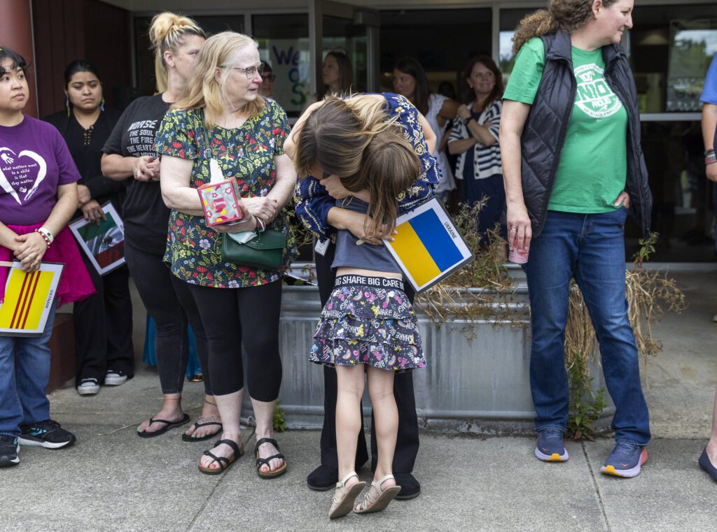 Student Azhura Brown, 5, hugs teacher Anzhelika Huliar on Wednesday, June 25, 2025 in Everett, Washington. (Olivia Vanni / The Herald)
