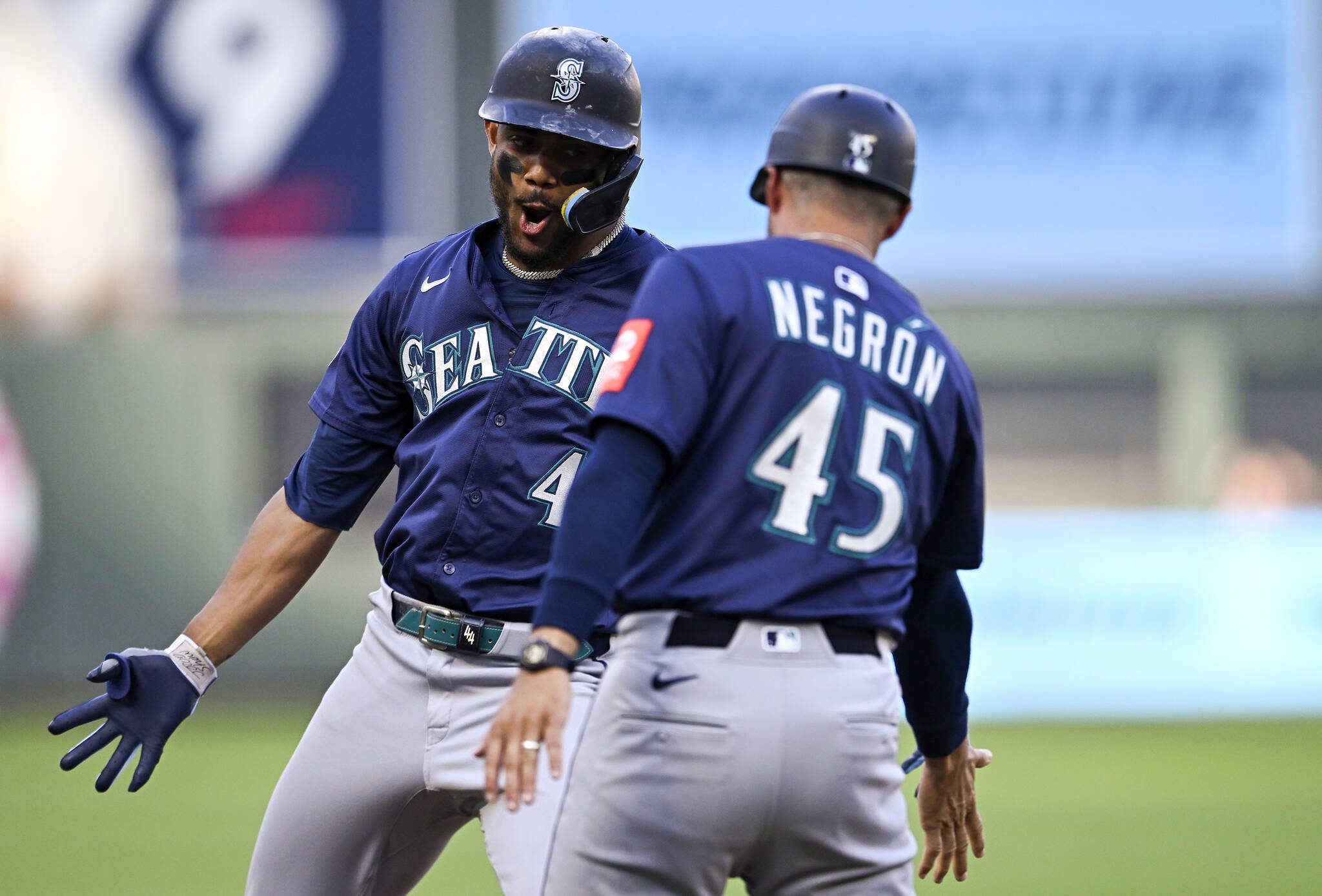 Julio Rodríguez (44) of the Seattle Mariners celebrates with Kristopher Negron (45) after hitting a two-run home run against the Minnesota Twins in the third inning of the game at Target Field on Monday, June 23, 2025, in Minneapolis. (Stephen Maturen / Getty Images / Tribune News Services)