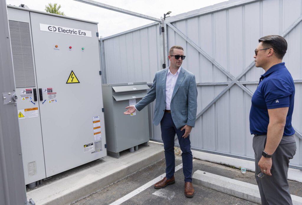 Electric Era Chief Revenue Officer Kyler Schmitz talks to Commerce Director Joe Nguyễn about their battery on Tuesday, June 24, 2025 in Arlington, Washington. (Olivia Vanni / The Herald)
