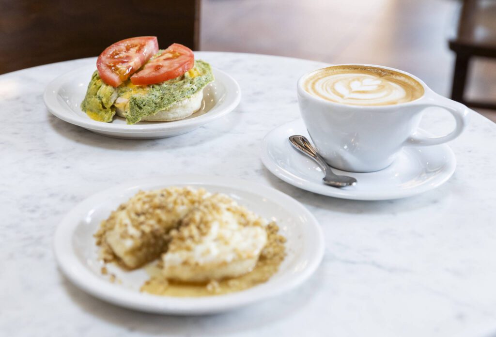 Rob’s Favorite crumpet with green egg, English cheese, tomato on smoked salmon cream cheese and The Walrus crumpet with walnuts and ricotta honey on Tuesday, June 24, 2025 in Edmonds, Washington. (Olivia Vanni / The Herald)
