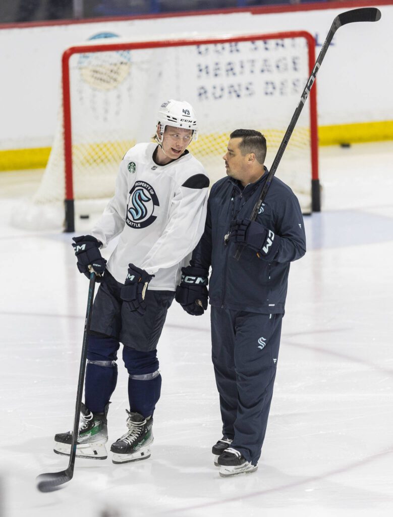 Julius Miettinen talks with a coach during Kraken Development Camp on-ice session for forwards on Tuesday, July 1, 2025 in Seattle, Washington. (Olivia Vanni / The Herald)
