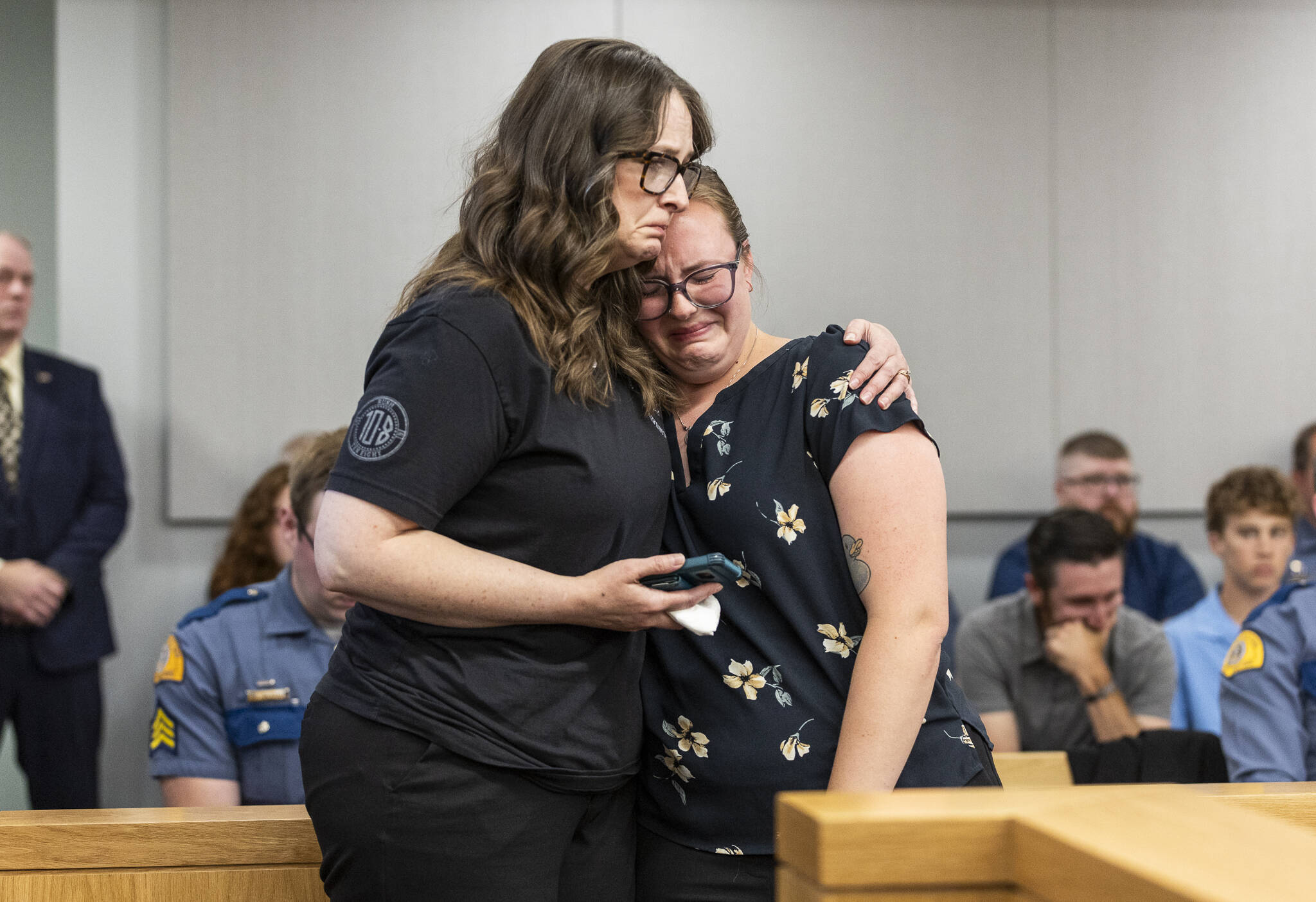 Washington State Patrol Trooper Christopher Gadd’s mother Gillian Gadd, left, comforts his wife Cammryn Gadd during the sentencing hearing at the Snohomish County Courthouse for Raul Benitez Santana on Wednesday, July 2, 2025 in Everett, Washington. (Olivia Vanni / The Herald)