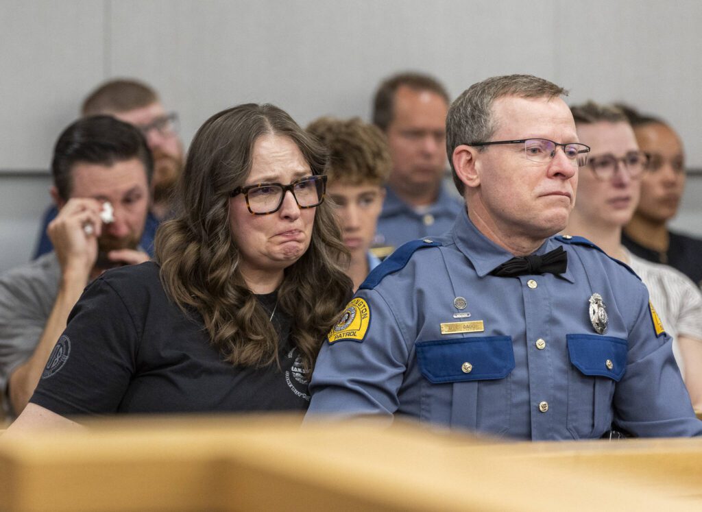 Washington State Patrol Trooper Christopher Gadd’s parents Gillian Gadd and WSP Trooper David Gadd listen as the judge delivers her sentence for Raul Benitez Santana during his hearing at the Snohomish County Courthouse on Wednesday, July 2, 2025 in Everett, Washington. (Olivia Vanni / The Herald)
