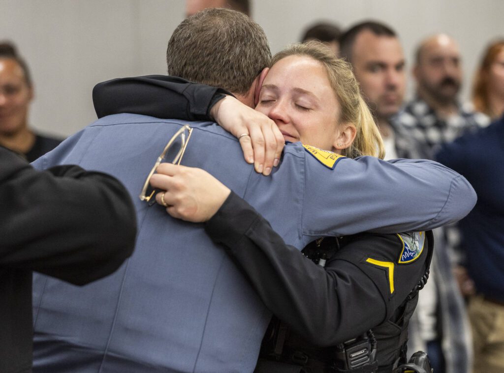 Rebecca Bonnell hugs David Gadd after Raul Benitez Santana is given the maximum sentence during his hearing at the Snohomish County Courthouse on Wednesday, July 2, 2025 in Everett, Washington. (Olivia Vanni / The Herald)
