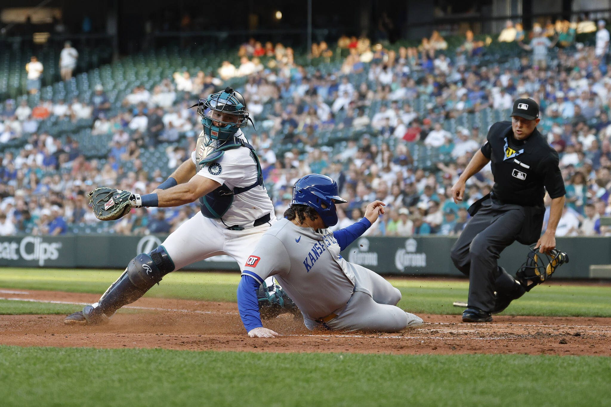 The Kansas City Royals’ Vinnie Pasquantino (9) safely slides home to score on Salvador Perez’s double during the fifth inning against the Seattle Mariners at T-Mobile Park on Tuesday, July 1, 2025, in Seattle. (Alika Jenner / Getty Images / Tribune News Services)