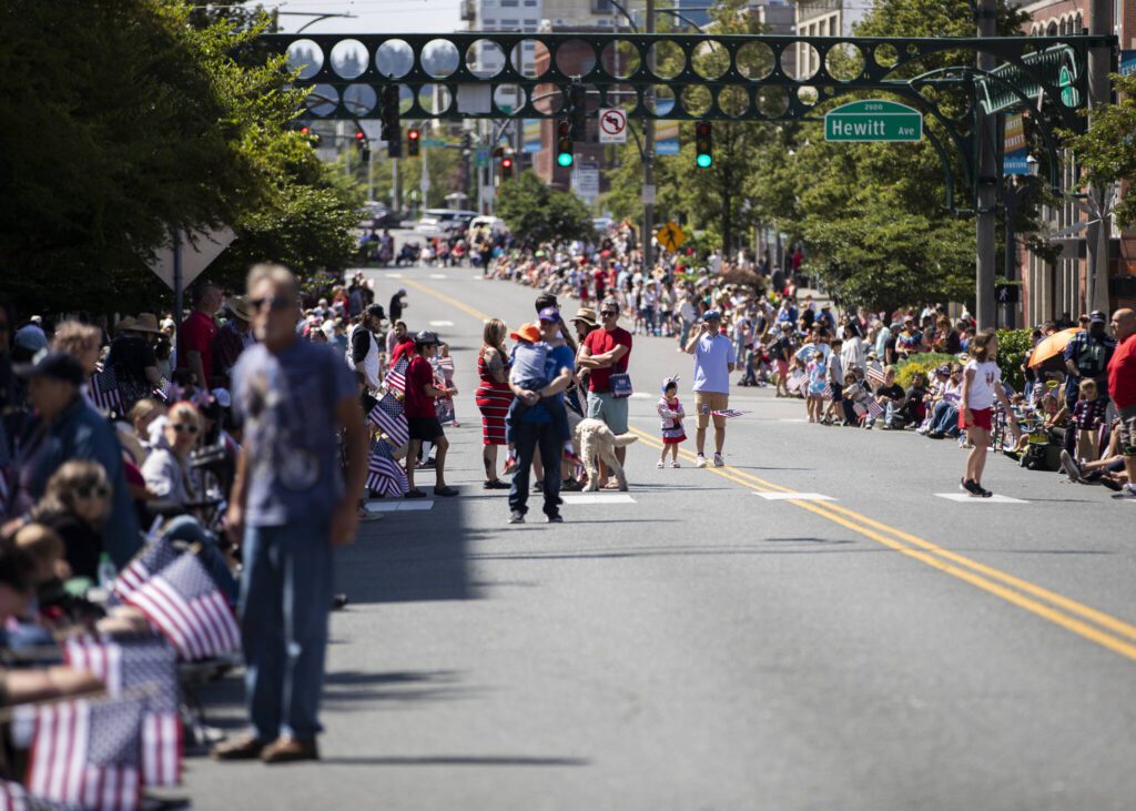 People line the sides of Colby Avenue during the Fourth of July parade on Friday, July 4, 2025 in Everett, Washington. (Olivia Vanni / The Herald)
