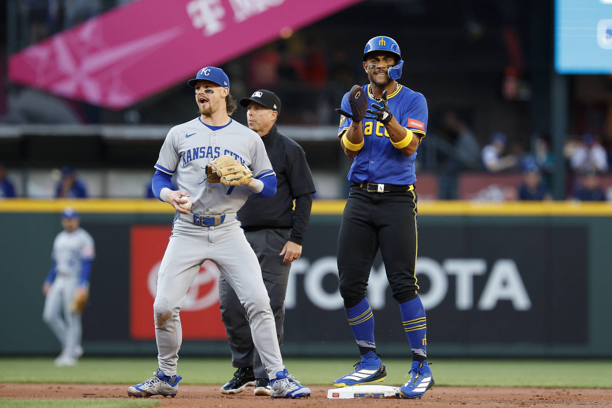 The Seattle Mariners’ Julio Rodríguez, right, claps after stealing second base during the first inning against the Kansas City Royals at T-Mobile Park on Thursday, July 3, 2025, in Seattle. (Alika Jenner / Getty Images / Tribune News Services)