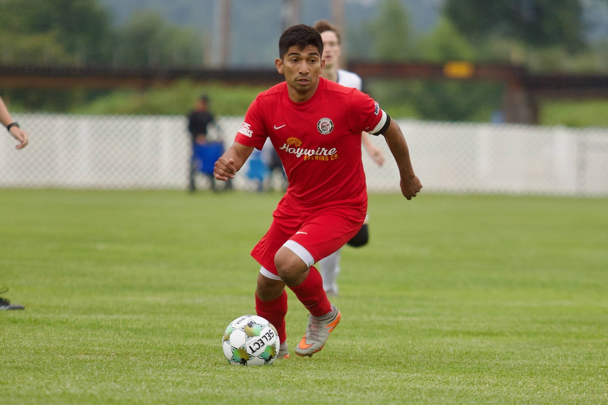Midfielder Christian Soto dribbles up field during Snohomish United’s 5-1 win against the Tacoma Stars at Stockers Fields on July 9, 2025 (Joe Pohoryles / The Herald)