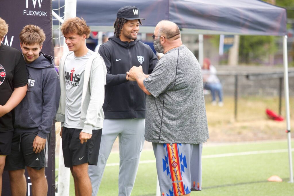 Rome Odunze greets the volunteers ahead of his youth football camp at Archbishop Murphy High School on July 10, 2025. (Joe Pohoryles / The Herald)
