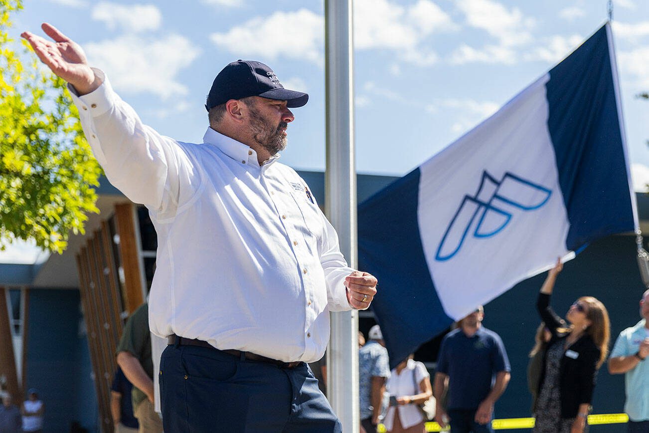 Monroe Mayor Geoffrey Thomas talks to the crowd about the new "Imagine Monroe" city flag and symbol before the ribbon cutting on Monday, July 14, 2025 in Monroe, Washington. (Olivia Vanni / The Herald)