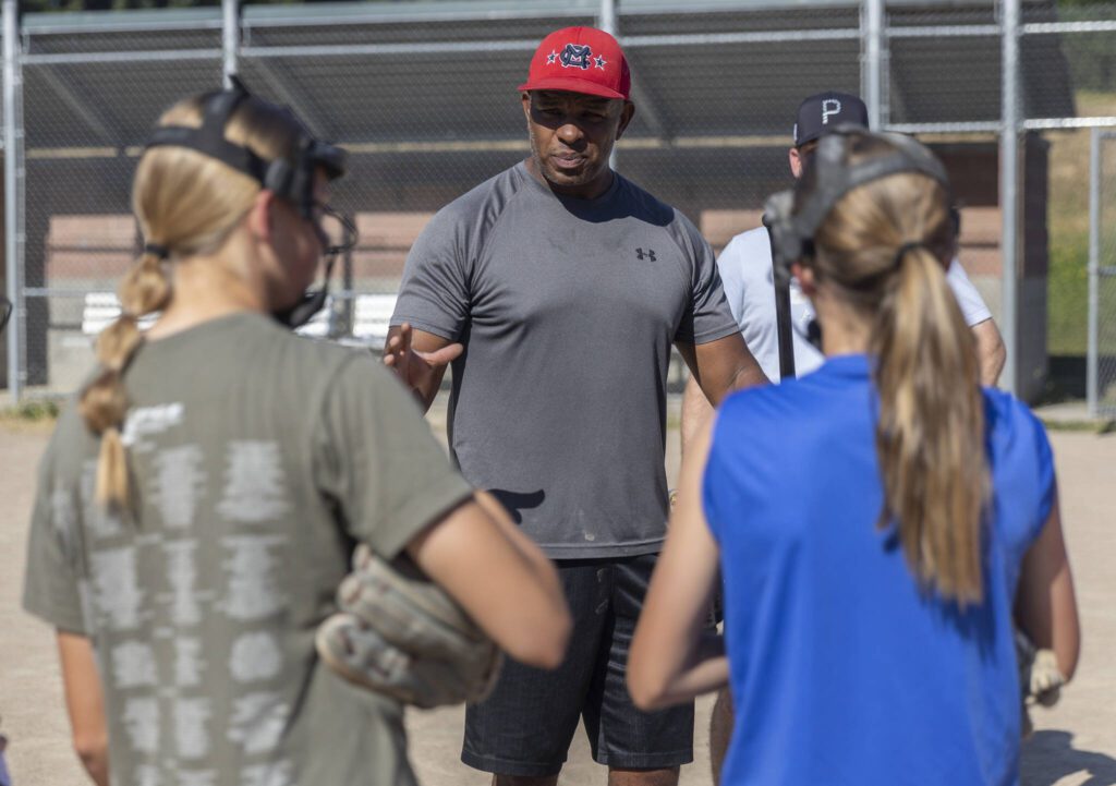 Mill Creek Little League softball Coach Courtney Brown talks to his players during practice on Wednesday, July 16, 2025 in Mill Creek, Washington. (Olivia Vanni / The Herald)
