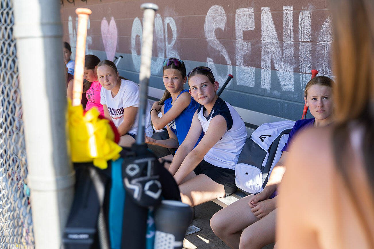 Mill Creek Little League softball players listen to former players talk about their experiences at regionals before the start of their practice on Wednesday, July 16, 2025 in Mill Creek, Washington. (Olivia Vanni / The Herald)