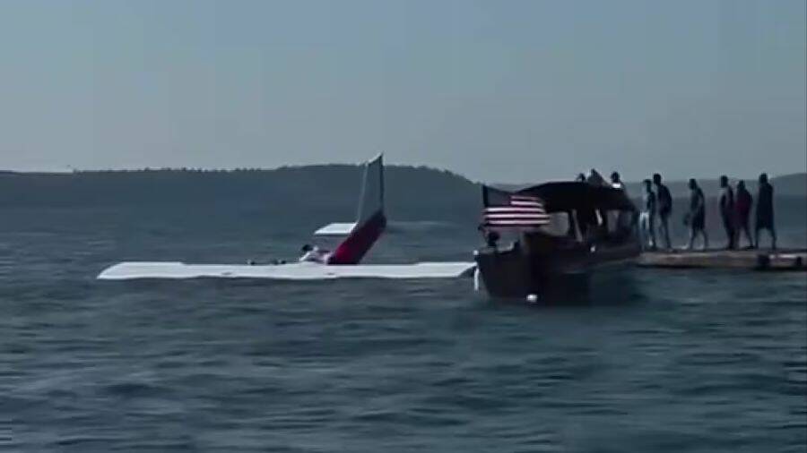 Screenshot from a video given by a bystander to police. The Cessna plane is floating in the water near Lighthouse Park in Mulkilteo as the three occupants try to escape. Rescuers wait to help nearby. (Photo provided by Mulkiteo Police Department)
