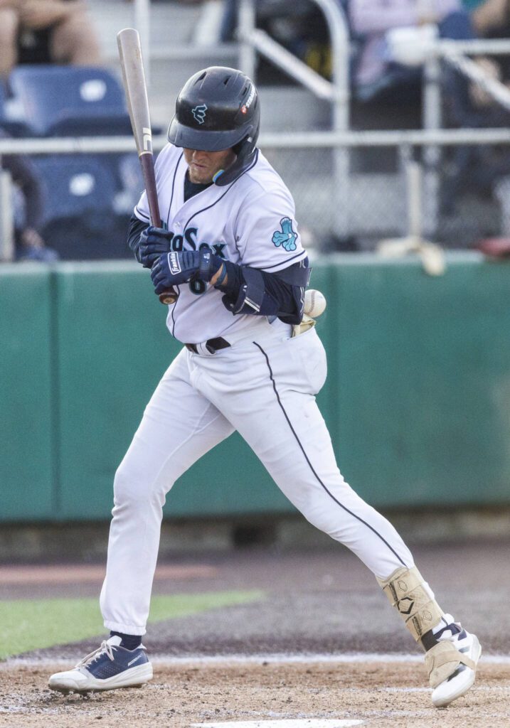 Everett AquaSox outfielder Colin Davis gets hit by a pitch during the game against the Spokane Indians on Tuesday, July 22, 2025 in Everett, Washington. (Olivia Vanni / The Herald)
