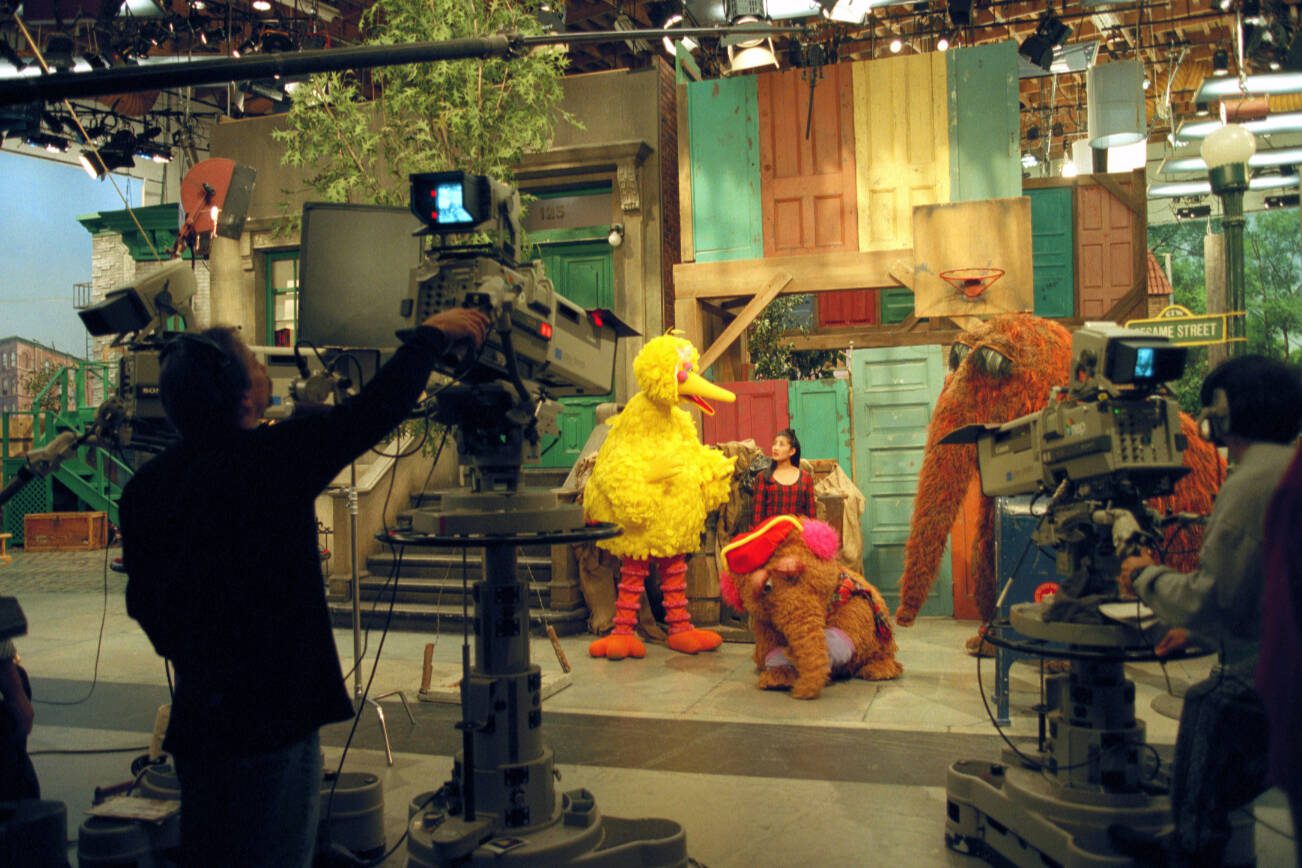 FILE — Cast and crew tape an episode of “Sesame Street” in New York on Nov. 8, 1995. Known for popular programs like “Sesame Street” and “Fresh Air,” PBS and NPR depend on public funding for local news, educational programming and emergency alerts. (Sara Krulwich/The New York Times)