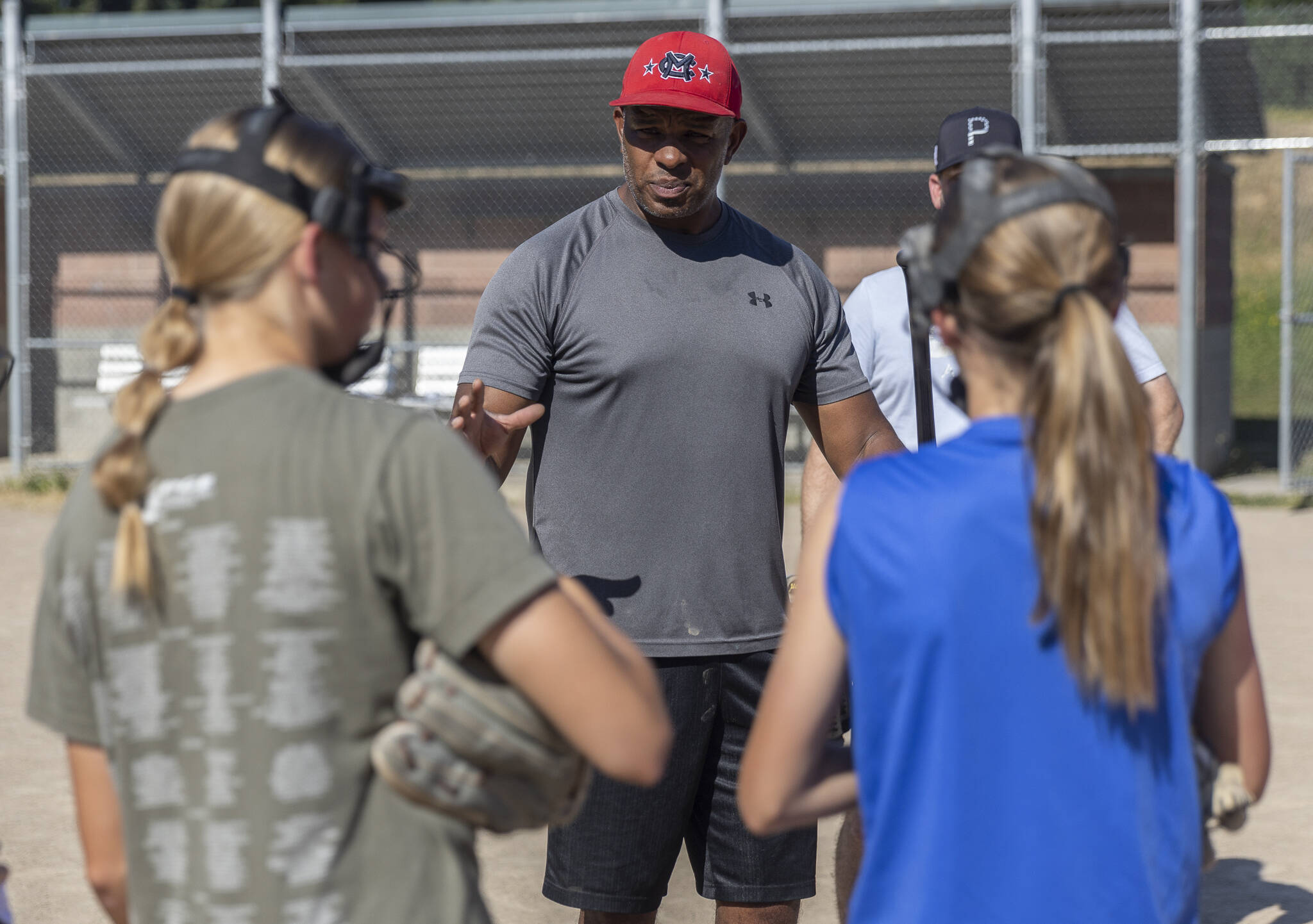 Mill Creek Little League softball Coach Courtney Brown talks to his players during practice on Wednesday, July 16, 2025 in Mill Creek, Washington. (Olivia Vanni / The Herald)
