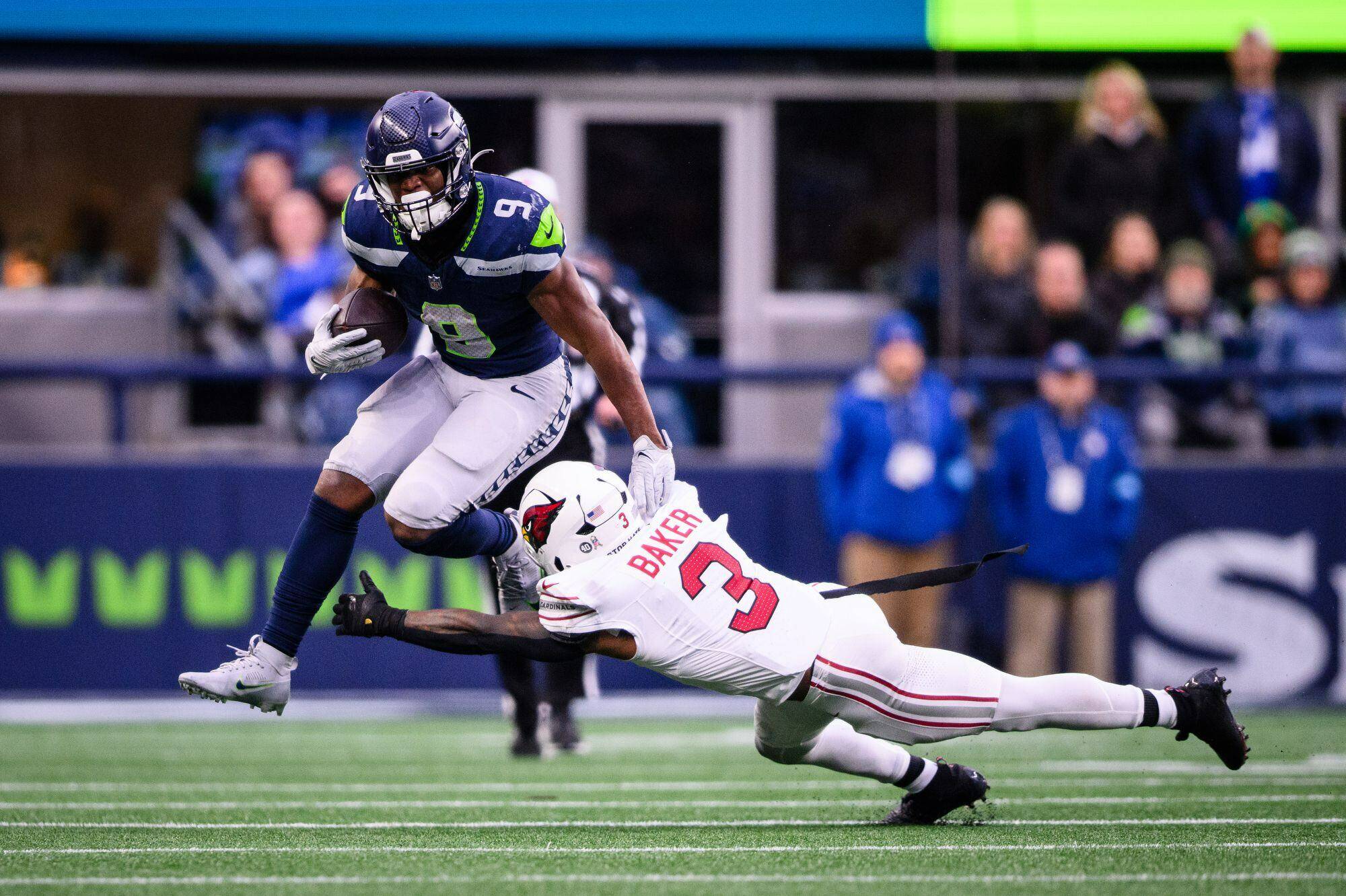 Seattle's Kenneth Walker III (9) tries to leap past Arizona's Budda Baker (3) during an NFL game on Sunday, Nov. 24, 2024, at Lumen Field in Seattle. (Naji Saker / Tribune News Services)