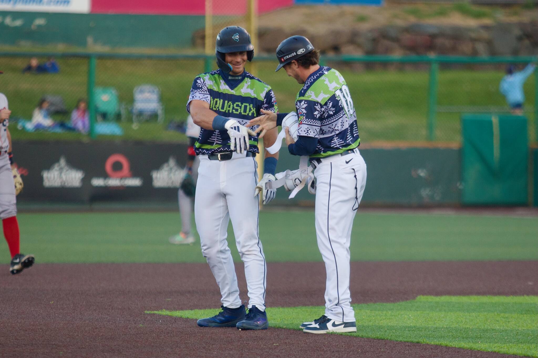 AquaSox infielder Charlie Pagliarini (left) laughs with manager Zach Vincej after hitting his third double of the game during Everett's 7-1 win against the Spokane Indians at Funko Field on July 25, 2025. (Joe Pohoryles / The Herald)