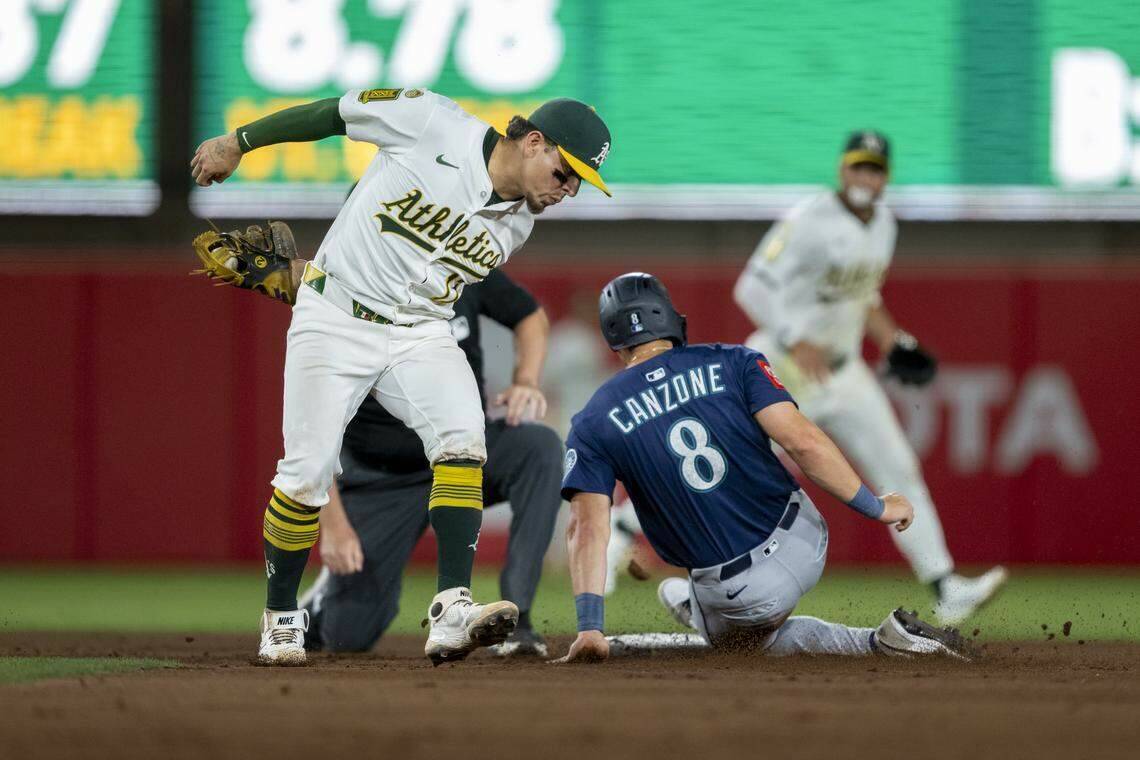 Athletics second baseman Luis Urías (17) attempts to apply a tag as Seattle Mariners outfielder Dominic Canzone (8) steals second base in the ninth inning during a baseball game at Sutter Health Park in West Sacramento on Monday. (Daniel Heuer / The Sacramento Bee / Tribune News Services)
