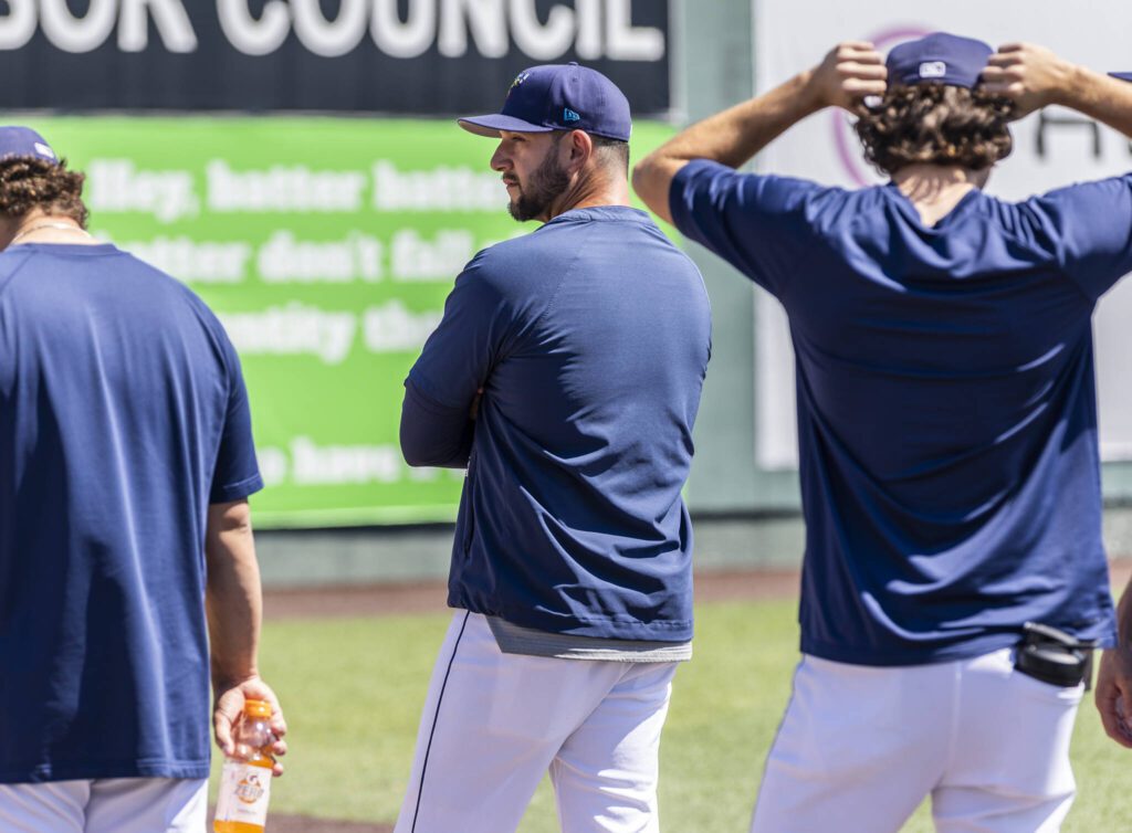 AquaSox pitching coach Matt Carasiti watches the starting pitcher warm-up before the start of a game on Thursday, July 24, 2025 in Everett, Washington. (Olivia Vanni / The Herald)
