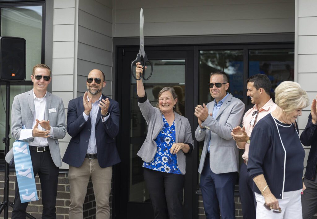 Sen. June Robinson raises scissors after the ribbon cutting for the new Marysville Family YMCA Early Learning Center on Tuesday, Aug. 5, 2025 in Marysville, Washington. (Olivia Vanni / The Herald)
