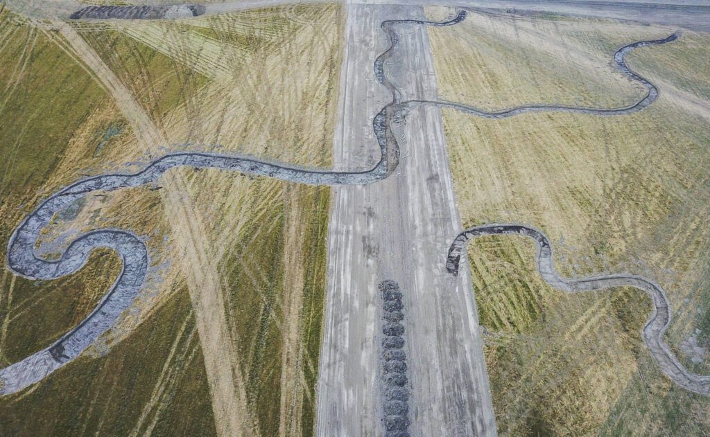 Excavator dug channels cover the surface of the Zis A Ba site on Wednesday, Aug. 6, 2025 in Stanwood, Washington. (Olivia Vanni / The Herald)
