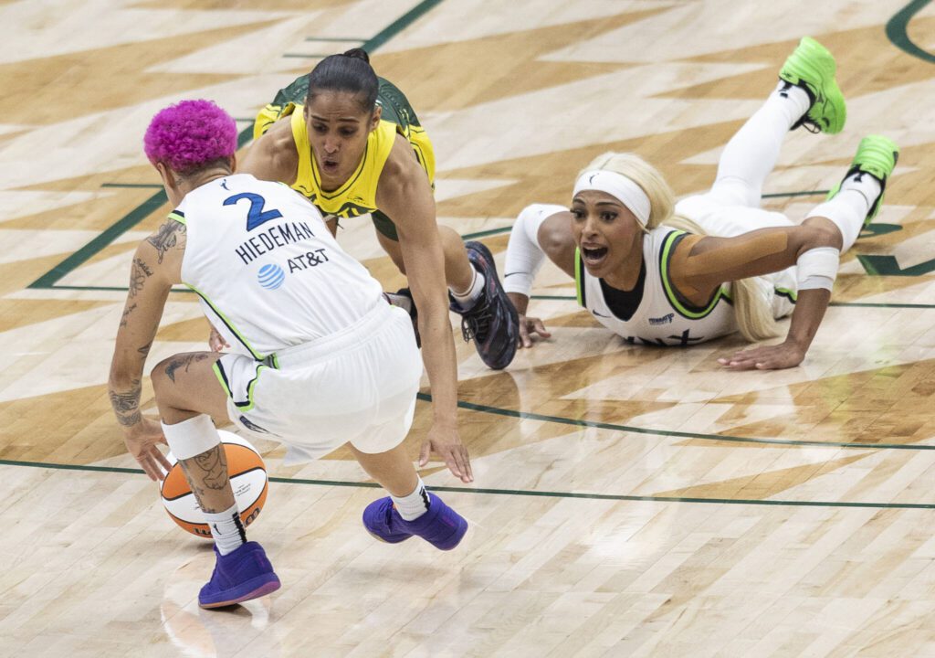 Seattle Storm&rsquo;s Skylar Diggins and Minnesota Lynx Natisha Hiedeman scramble after a loose ball during the game on Tuesday, Aug. 5, 2025 in Seattle, Washington. (Olivia Vanni / The Herald)
