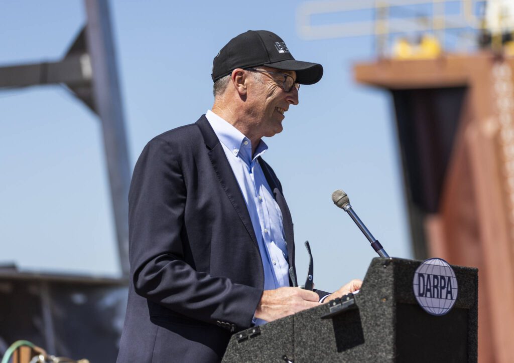 Nichols Brothers Boat Builders CEO Gavin Higgins speaks at the christening of the USX-1 Defiant, a first-of-its-kind autonomous naval ship, at Everett Ship Repair on Monday, Aug. 11, 2025 in Everett, Washington. (Olivia Vanni / The Herald)
