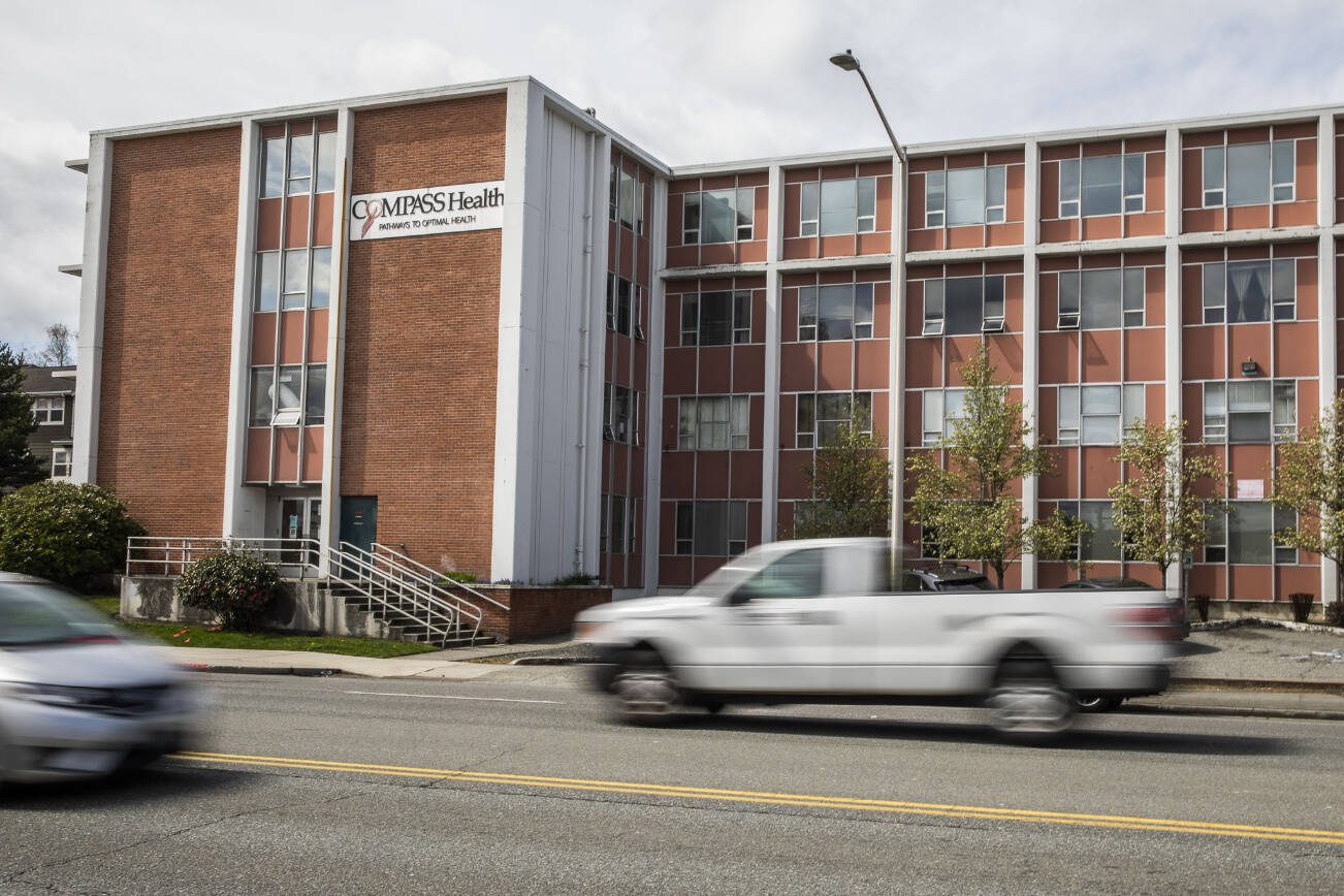 Traffic moves along Broadway in front of Compass Heath, one of the buildings that would fall under the no sit, not lie ordnance extension on Tuesday, April 18, 2023 in Everett, Washington. (Olivia Vanni / The Herald)
