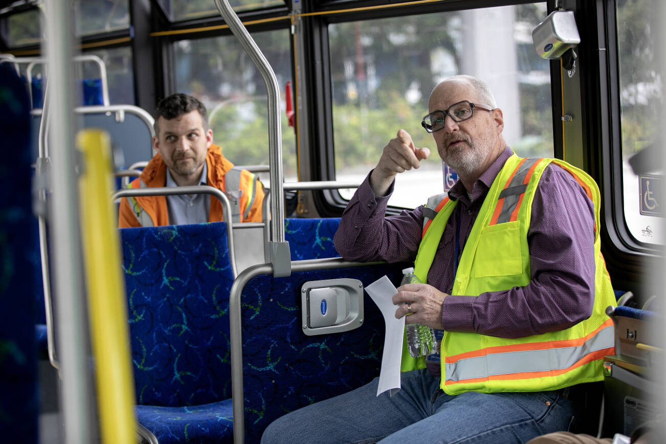 Community Transit CEO Ric Ilgenfritz, right, speaks with other Community Transit leaders during an interview with the Herald on a new electric bus Monday, May 13, 2024, at the Community Transit Operations Base in Everett, Washington. (Ryan Berry / The Herald)