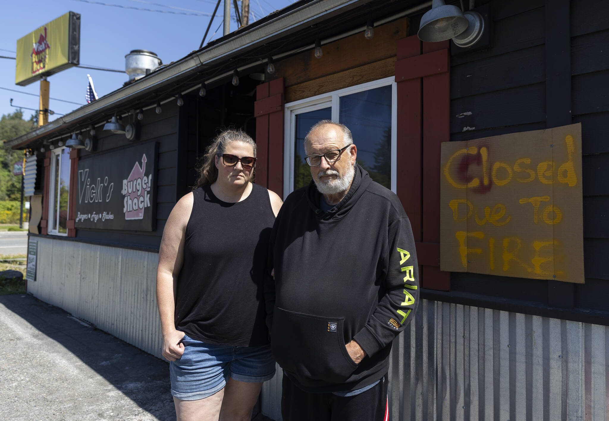 Jen Vick, left, and her father Marc Vick, right, one of the co-owners of Vick’s Burger Shack stand in front of their business on Wednesday, Aug. 13, 2025 in Sultan, Washington. (Olivia Vanni / The Herald)