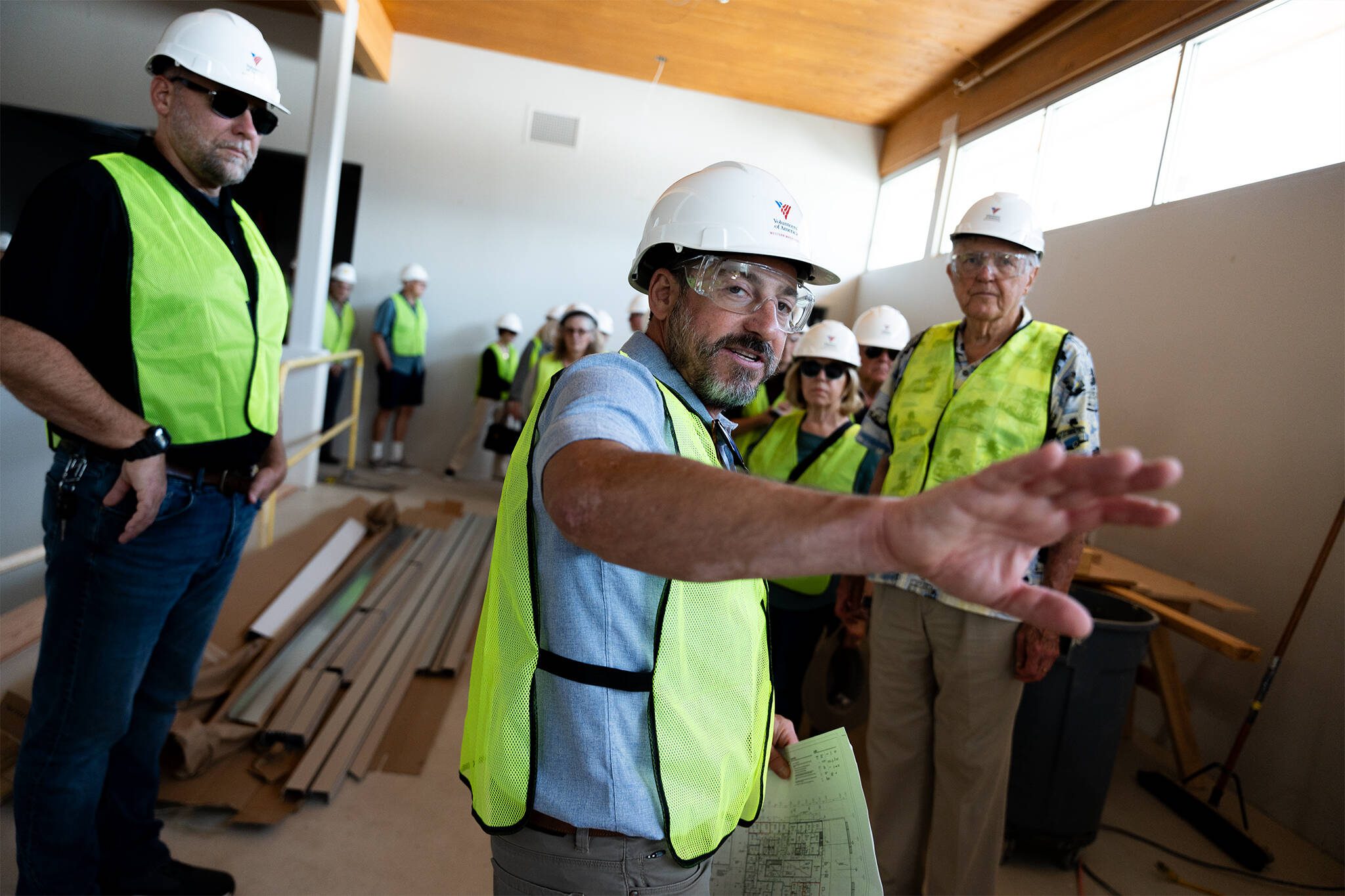 Joel Feldman, a philanthropy officer at Volunteers of America Western Washington, leads members of local Rotary clubs on a tour of the Lynnwood Neighborhood Center on Thursday, Aug. 14 in Lynnwood, Washington. (Will Geschke / The Herald)