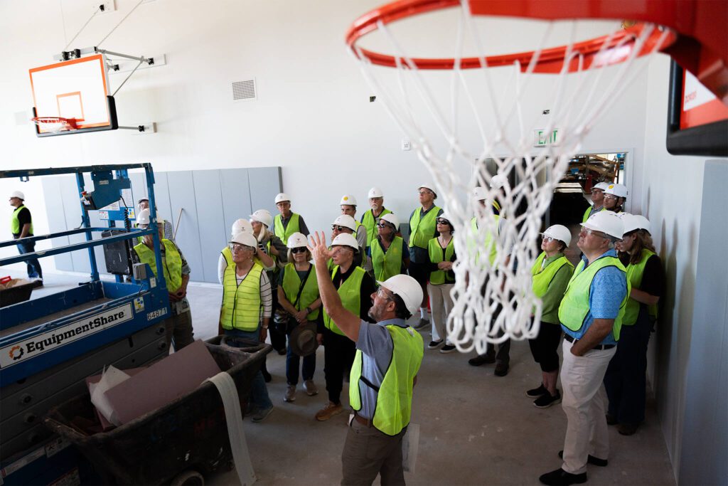 Members of local Rotary clubs tour the Lynnwood Neighborhood Center’s gymnasium on Thursday, Aug. 14 in Lynnwood, Washington. (Will Geschke / The Herald)
