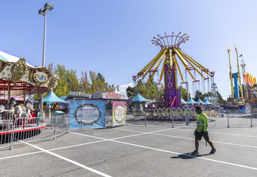 Workers set up rides at the Evergreen State Fair on Wednesday, Aug. 20, 2025 in Monroe, Washington. (Olivia Vanni / The Herald)
