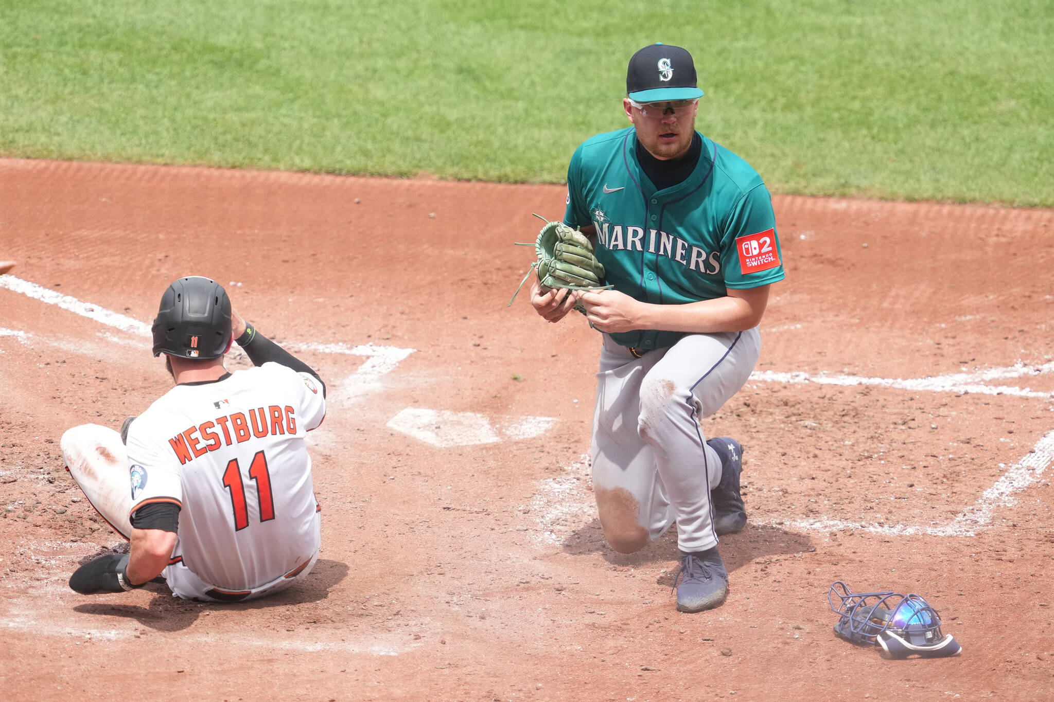 The Baltimore Orioles' Jordan Westburg (11) scores a run, beating the tag from Seattle Mariners pitcher Logan Evans, who threw a wild pitch in the fourth inning at Oriole Park at Camden Yards on Thursday, Aug. 14, 2025, in Baltimore. (Mitchell Layton / Getty Images / Tribune News Services)