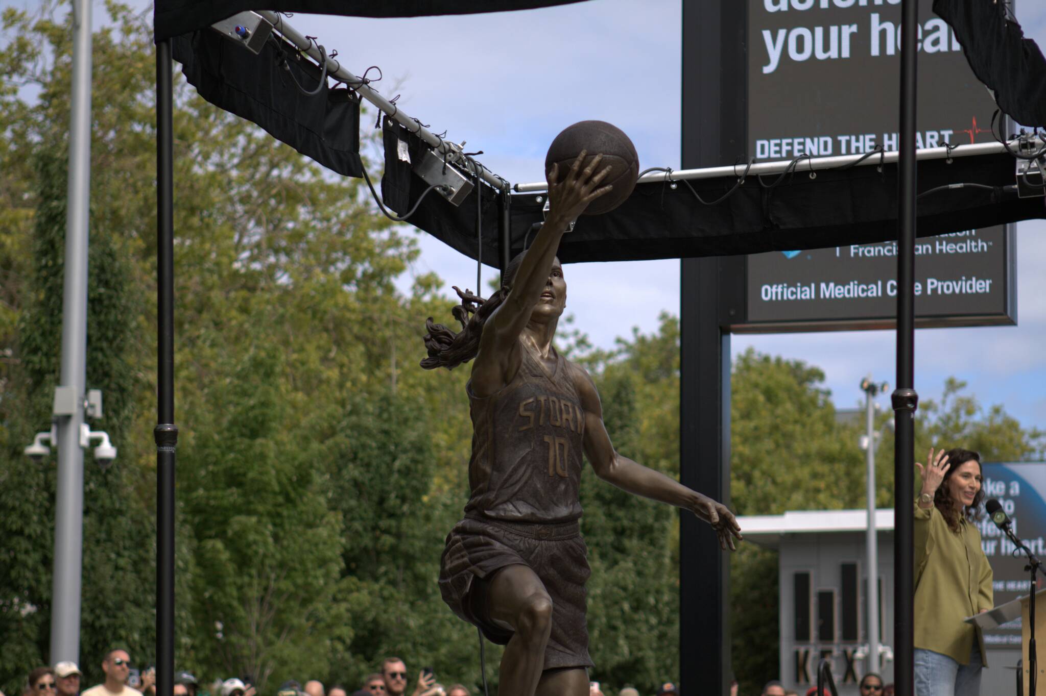 Seattle Storm Hall-of-Famer Sue Bird speaks while her statue is unveiled on Sunday, Aug. 17, 2025 outside of Climate Pledge Arena in Seattle. (Qasim Ali / The Herald)